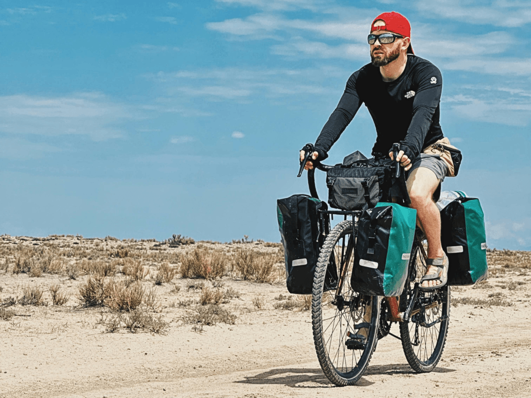 Cyclist riding a bike with front and rear panniers